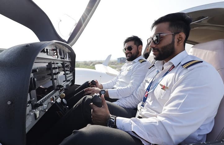 Pilot in helicopter cockpit with headset and controls